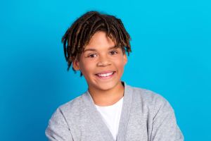 Smiling young man in front of blue background