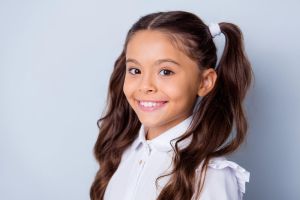 Smiling young girl with pigtails | Dental health | MyOrthodontist