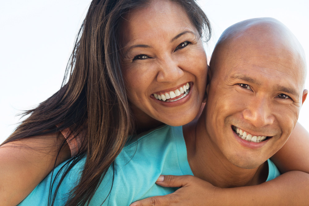 Smiling adult couple at the beach